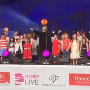Combined Darley Abbey Schools Choir signing in front of 25,000+ crowd
